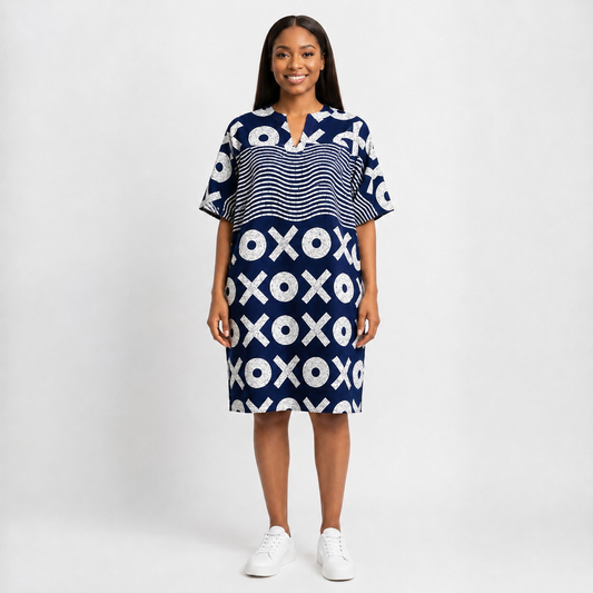 Woman wearing a blue dress with white patterns on a plain background